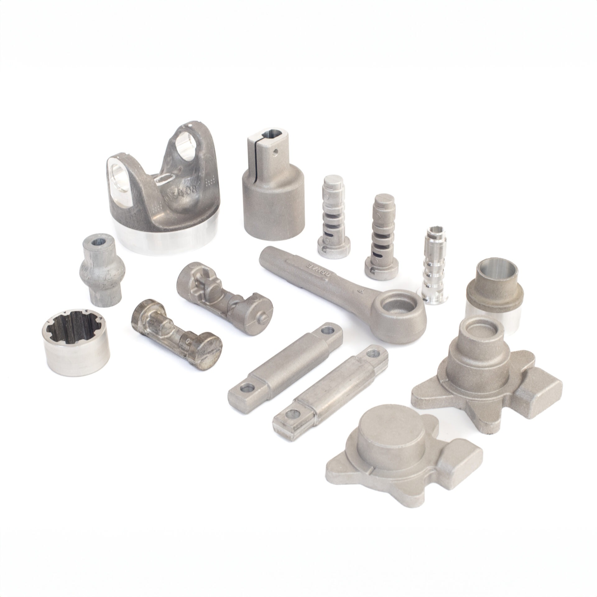 This image shows various industrial metal parts spread out on a white background, possibly components for machinery or automotive use.